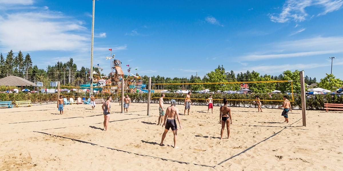 Guests playing sand volleyball